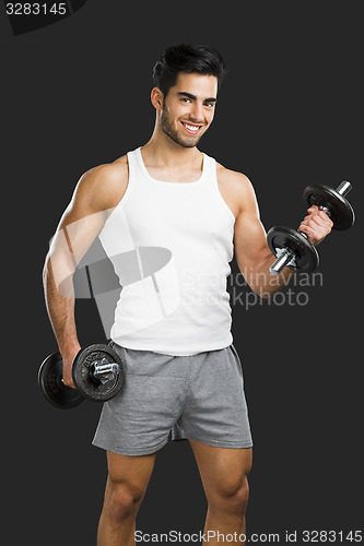 Image of Athletic man lifting weights