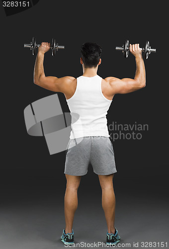 Image of Athletic man lifting weights