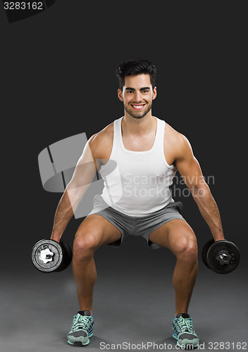 Image of Athletic man lifting weights