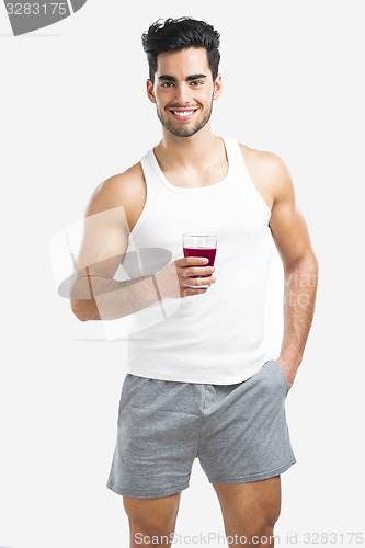 Image of Athletic man drinking a juice