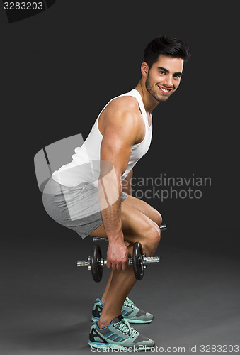 Image of Athletic man lifting weights