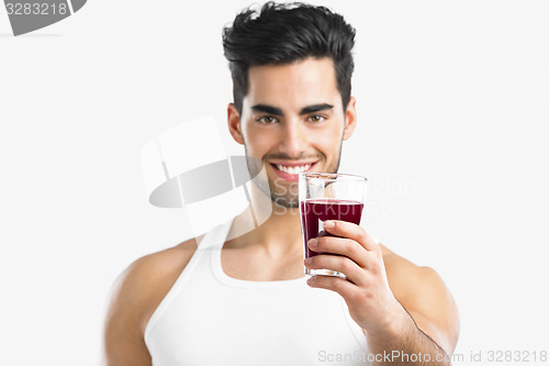 Image of Athletic man drinking a juice