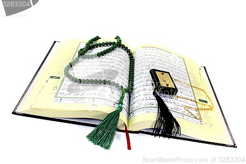 Image of whipped Quran with rosary