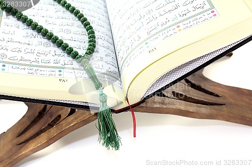 Image of stand with Quran and rosary