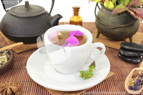 Image of Chinese natural medicine with a cup of tea and stones