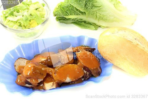 Image of Currywurst with lettuce