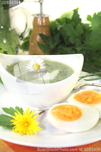 Image of green herb soup with a dollop of cream