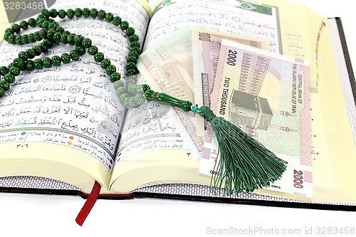 Image of whipped Quran with Iranian Rials