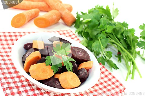 Image of fresh crisp orange and purple carrots