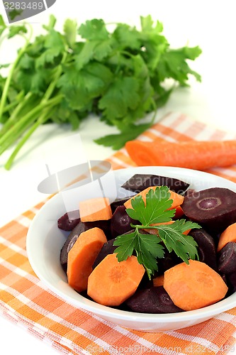 Image of fresh sliced orange and purple carrots