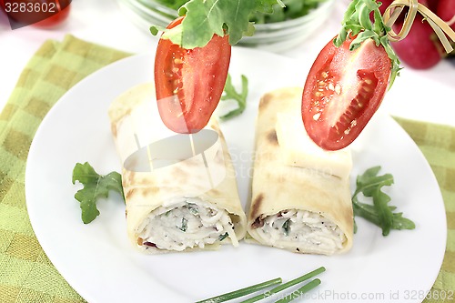 Image of stuffed cheese crepe rolls with tomatoes