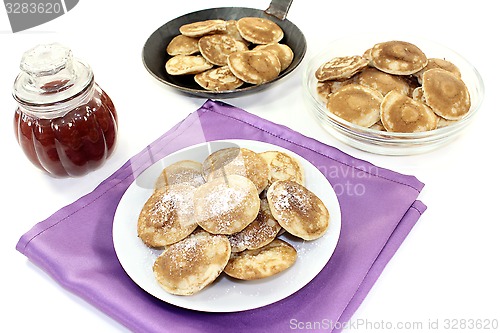 Image of Poffertjes with powdered sugar and fruit jelly