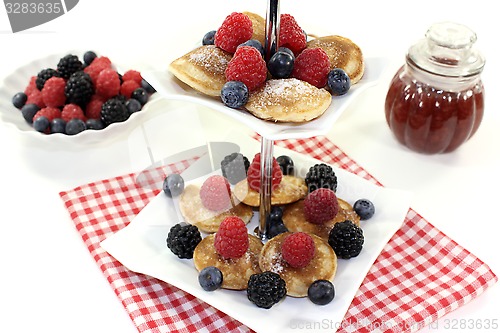 Image of Poffertjes with berries on a cake stand