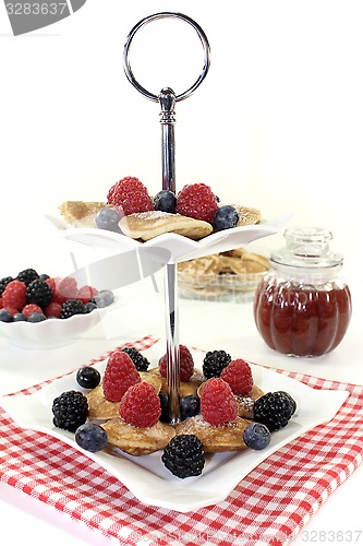 Image of Poffertjes with blackberries on a cake stand