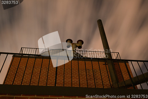 Image of Clouds in movement by a water tower