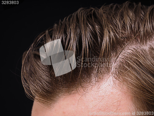 Image of Hairstyle on male person with brown hair at closeup isolated tow