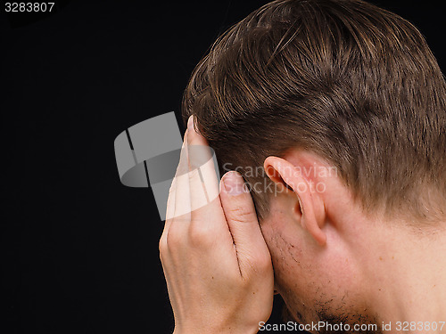 Image of Male caucasian person covering face with one hand isolated towar