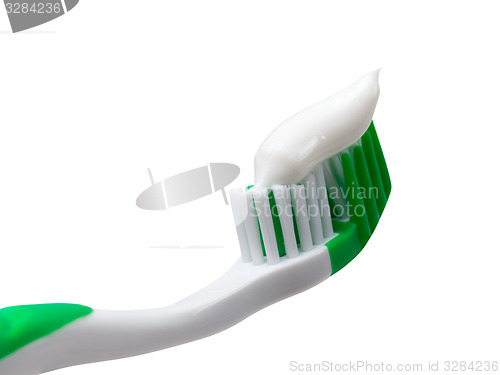 Image of Green toothbrush with toothpaste