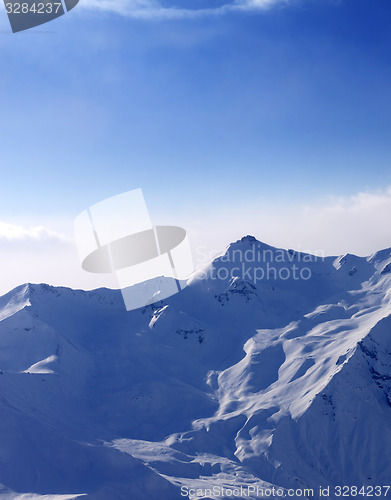 Image of Snowy mountains in mist at early morning