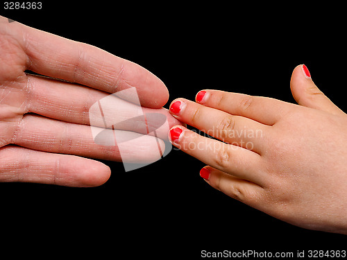 Image of Big hand palm meeting small girl hand with cracked pink nail pai