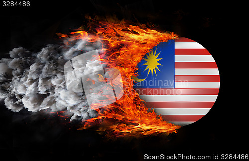 Image of Flag with a trail of fire and smoke - Malaysia