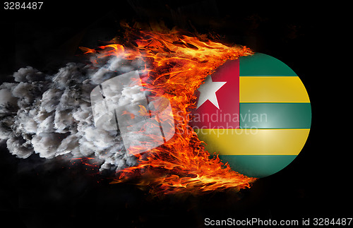 Image of Flag with a trail of fire and smoke - Togo