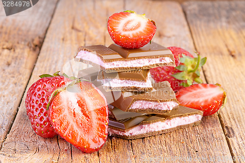 Image of chocolate with strawberry cream on wooden