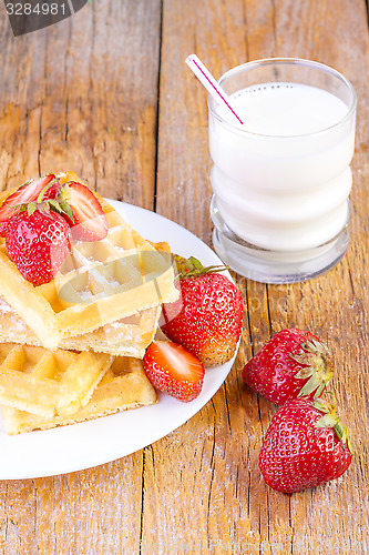 Image of homemade waffles with strawberries maple syrup