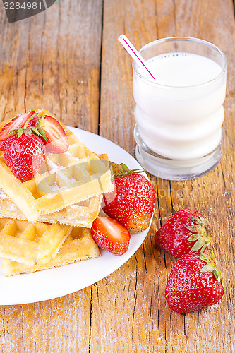 Image of homemade waffles with strawberries maple syrup