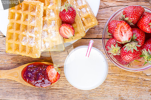 Image of homemade waffles with strawberries maple syrup