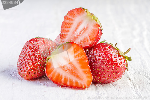 Image of strawberries on white wooden 