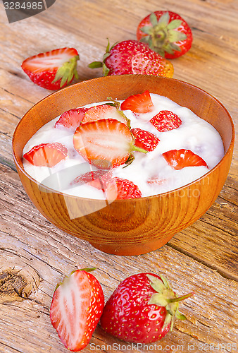 Image of fresh organic greek yogurt with strawberries on wooden