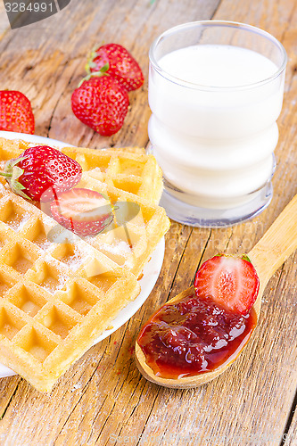 Image of homemade waffles with strawberries maple syrup
