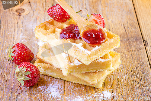 Image of homemade waffles with strawberries maple syrup