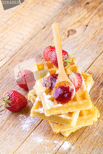 Image of homemade waffles with strawberries maple syrup