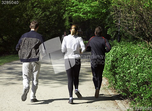 Image of Group of friends running in the park