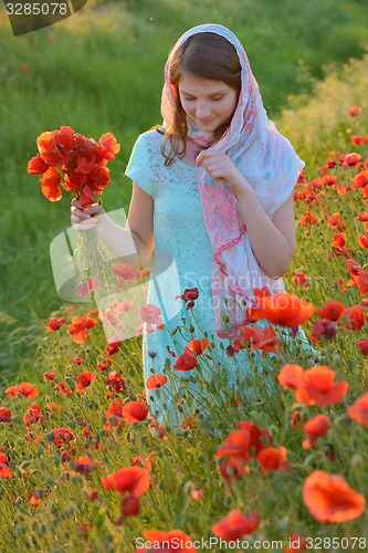 Image of girl  in field of poppies 
