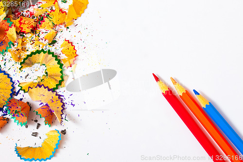 Image of three colored pencils and shavings