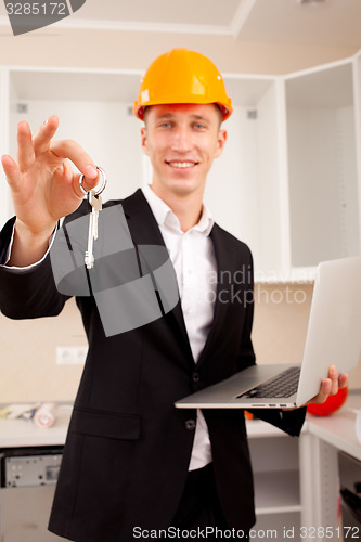 Image of smiling engineer gives keys