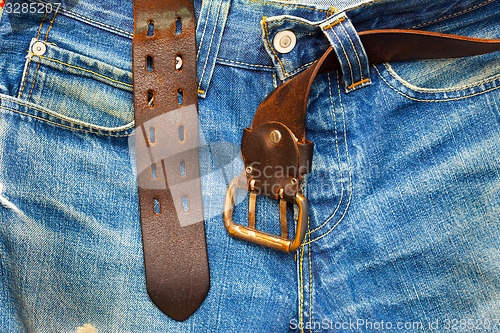 Image of aged jeans with unfastened belt
