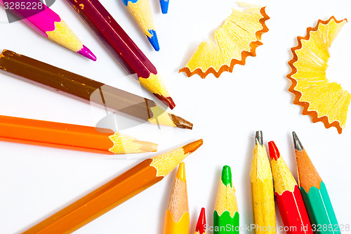 Image of colored pencils and shavings on white background