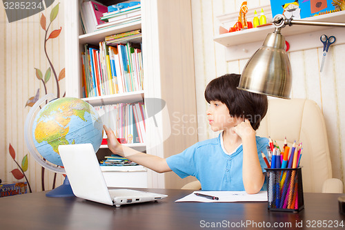 Image of studying geography, boy and globe