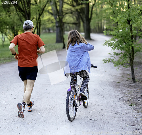 Image of Dad with daughter on bike 