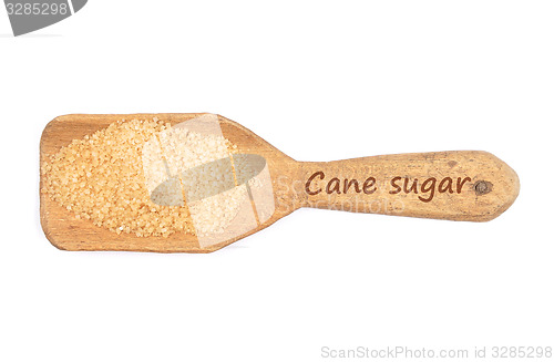 Image of Brown cane sugar on shovel