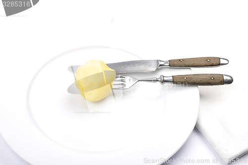 Image of Peeled potato on table