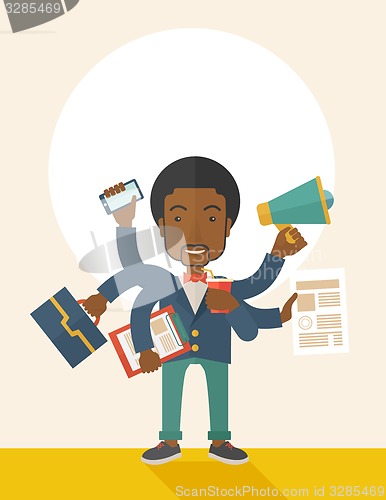 Image of Young but happy african employee doing multitasking office tasks.