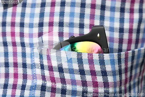 Image of Sunglasses in a shirt pocket.