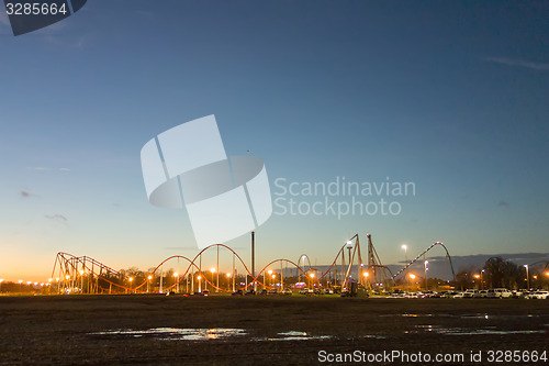 Image of sunset over an amusement park in a distance
