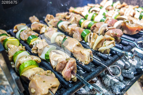 Image of shish kebab on skewers on a grill on a holiday