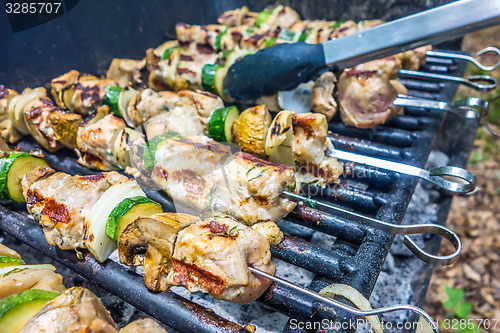 Image of steak shishkabob skewers with vegitables cooking on flaming gril